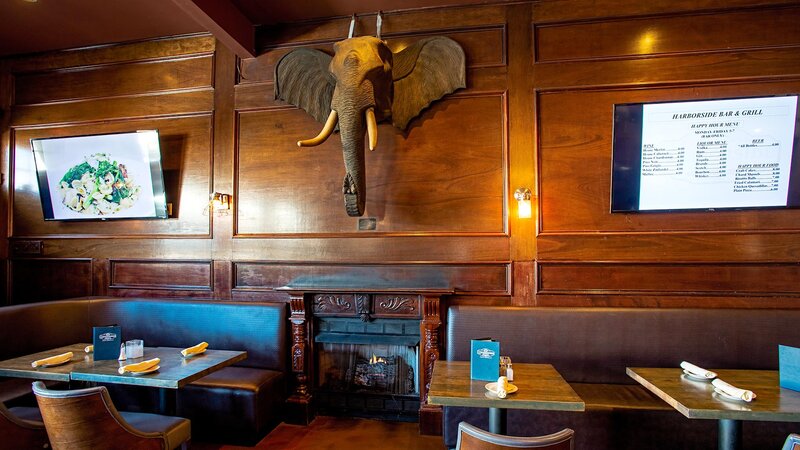 Dining room with booth seating and elephant trophy on the wall