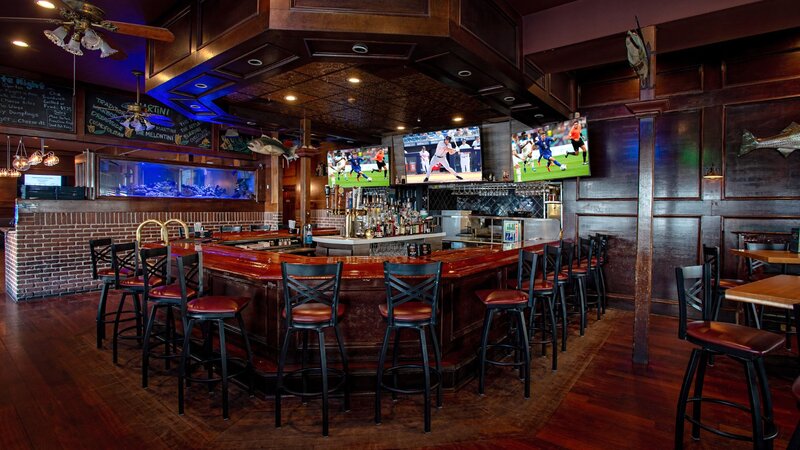Bar seating area with flat screen televisions